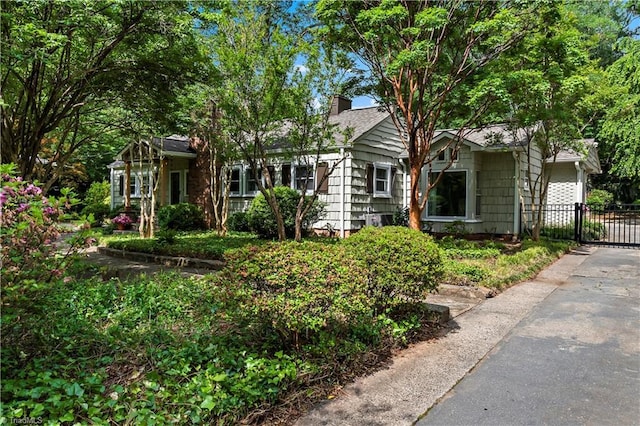 968 Avon Rd, Winston-Salem, NC 27104 - view of front of home featuring a chimney, a gate, and fence