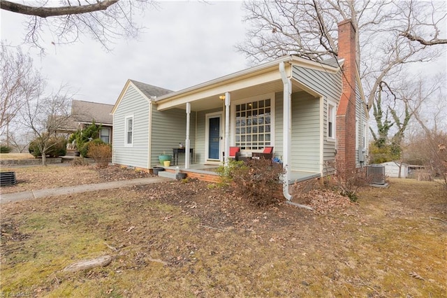 view of front of property featuring cooling unit and a porch