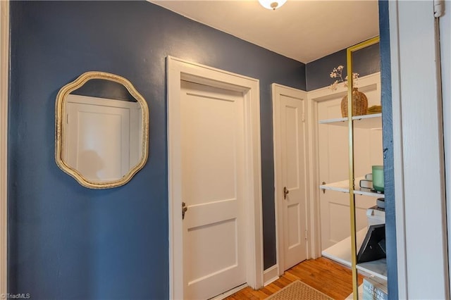 corridor with light hardwood / wood-style flooring