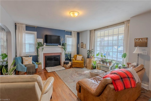 living room featuring hardwood / wood-style flooring and a fireplace