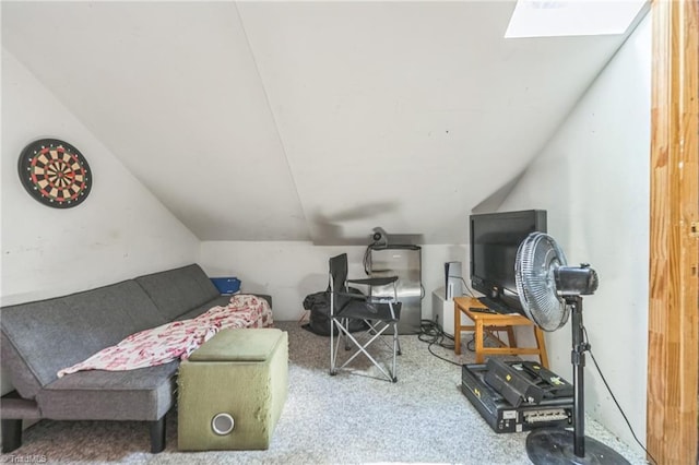 interior space featuring vaulted ceiling, a skylight, and carpet floors