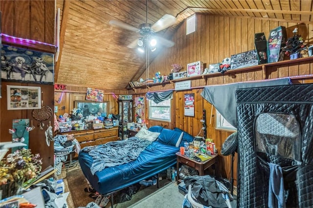 bedroom with wooden ceiling, vaulted ceiling, and wood walls