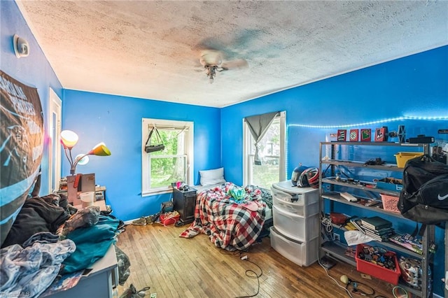 bedroom featuring a textured ceiling and wood-type flooring