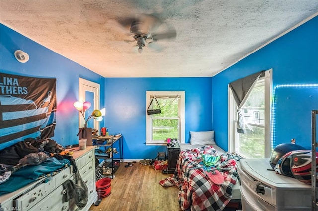 bedroom featuring hardwood / wood-style floors and a textured ceiling