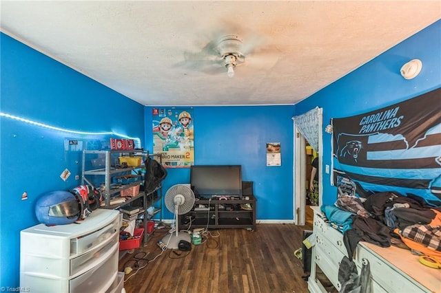 bedroom featuring wood finished floors, baseboards, and a ceiling fan