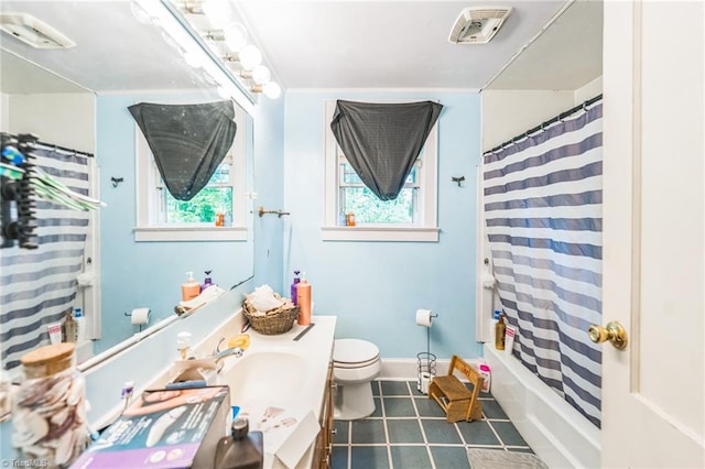 bathroom featuring tile patterned flooring, toilet, vanity, and shower / bath combo