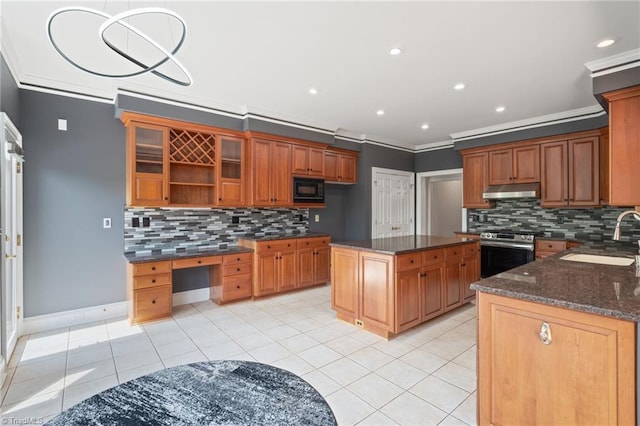 kitchen featuring decorative backsplash, crown molding, black microwave, a sink, and stainless steel range oven