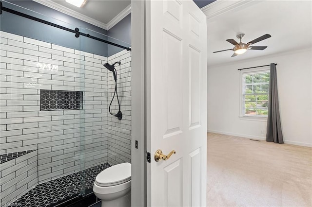 bathroom featuring ornamental molding, a ceiling fan, a shower stall, and toilet