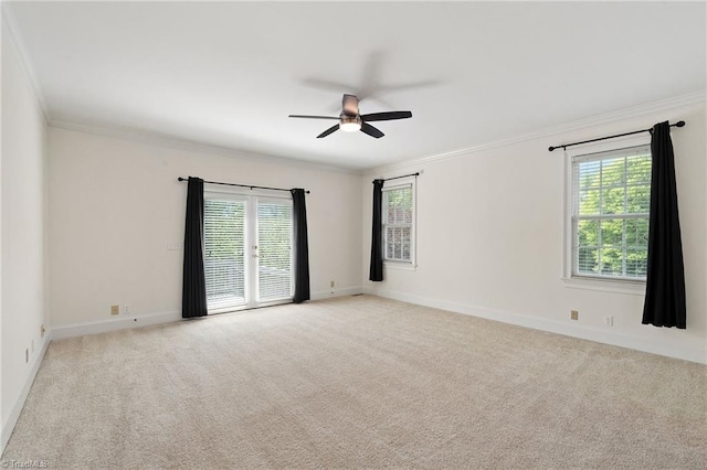 empty room with a ceiling fan, plenty of natural light, and ornamental molding