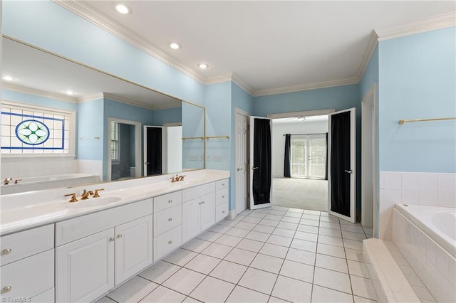 full bath featuring a sink, tile patterned floors, double vanity, and a bath
