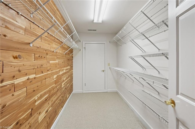 spacious closet featuring carpet flooring and visible vents