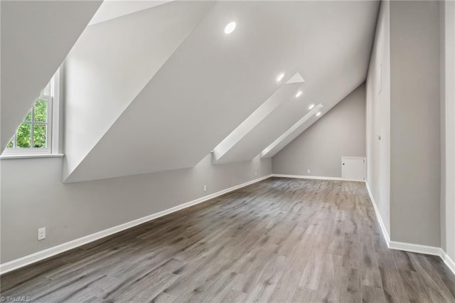bonus room with wood finished floors, recessed lighting, baseboards, and lofted ceiling