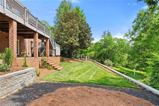 view of yard with stairs and a deck