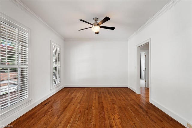 unfurnished room with crown molding, a ceiling fan, baseboards, and wood finished floors