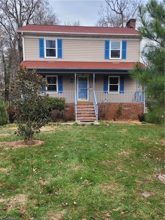 view of front of home featuring a front yard, crawl space, and a chimney