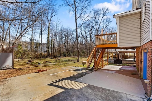 view of yard with a deck, a patio, and stairway