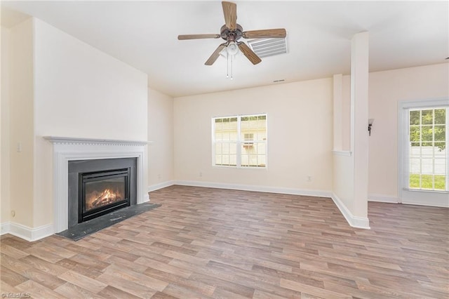1771 Timber Cove Ct, Winston-Salem, NC 27127 - unfurnished living room with light wood-style floors, a ceiling fan, a glass covered fireplace, and baseboards