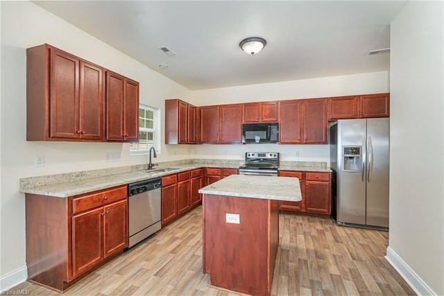 1771 Timber Cove Ct, Winston-Salem, NC 27127 - kitchen featuring appliances with stainless steel finishes, a sink, light wood-type flooring, and baseboards