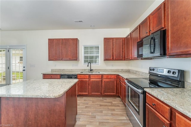 1771 Timber Cove Ct, Winston-Salem, NC 27127 - kitchen featuring electric range, black microwave, a sink, reddish brown cabinets, and light wood-style flooring
