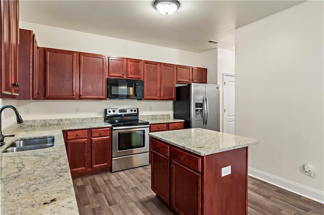 1771 Timber Cove Ct, Winston-Salem, NC 27127 - kitchen featuring appliances with stainless steel finishes, a sink, dark brown cabinets, dark wood finished floors, and a center island