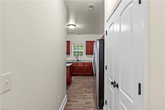 1771 Timber Cove Ct, Winston-Salem, NC 27127 - hallway with a sink, wood finished floors, and baseboards