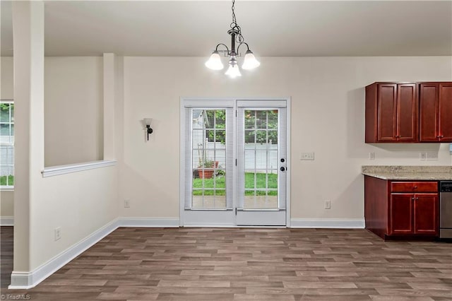 1771 Timber Cove Ct, Winston-Salem, NC 27127 - unfurnished dining area with wood finished floors, baseboards, and a chandelier