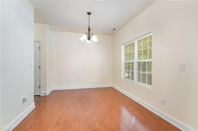1771 Timber Cove Ct, Winston-Salem, NC 27127 - unfurnished room featuring a chandelier, wood finished floors, and baseboards
