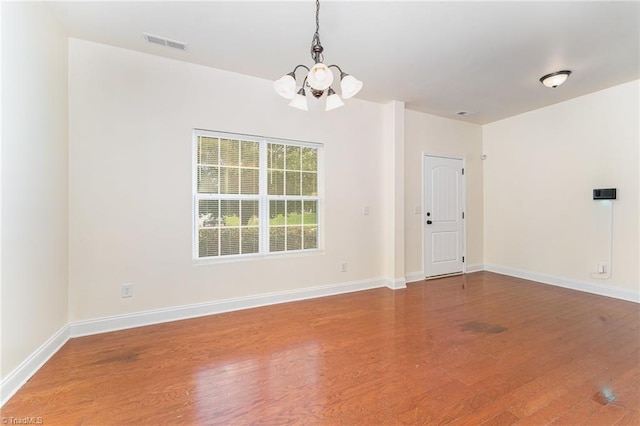 1771 Timber Cove Ct, Winston-Salem, NC 27127 - unfurnished room featuring a chandelier, wood finished floors, and baseboards