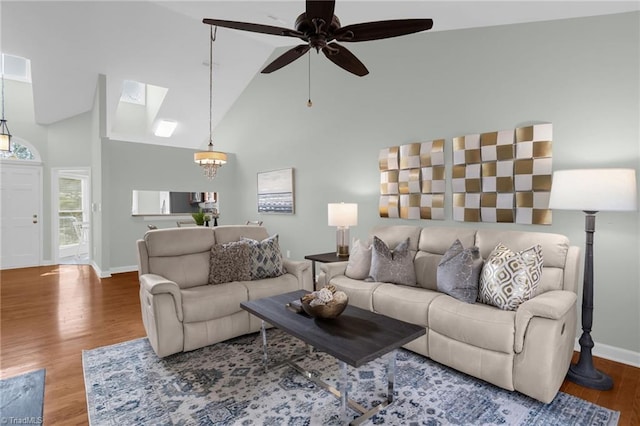 living room featuring hardwood / wood-style flooring, high vaulted ceiling, and ceiling fan