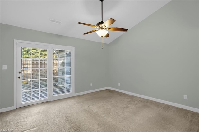 carpeted empty room with vaulted ceiling and ceiling fan