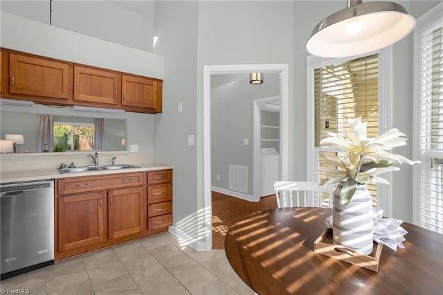 kitchen featuring dishwasher, sink, and light tile patterned floors