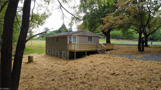 rear view of property with a wooden deck