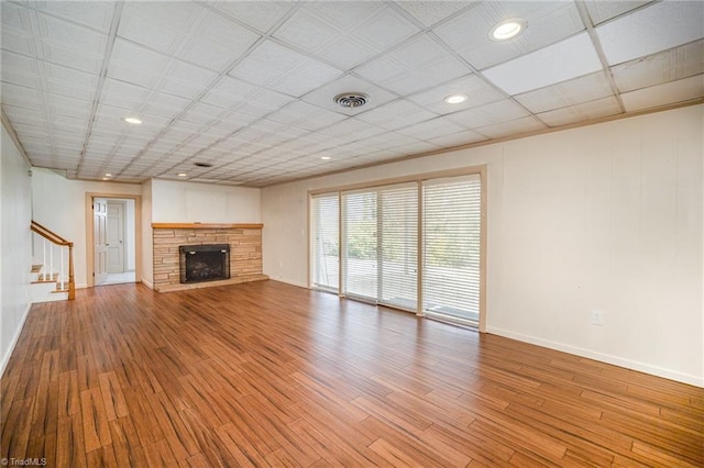 unfurnished living room featuring a fireplace and light hardwood / wood-style floors