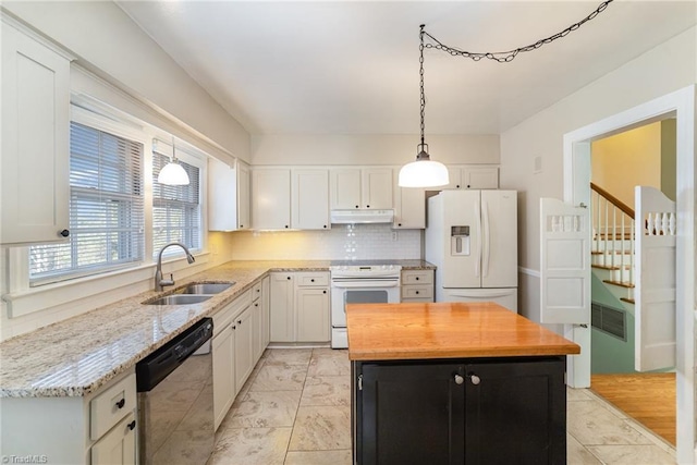 kitchen with pendant lighting, sink, white cabinets, decorative backsplash, and white appliances