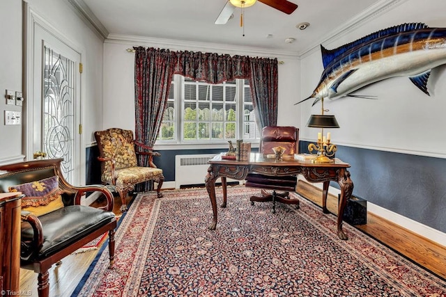 home office featuring wood-type flooring, crown molding, radiator heating unit, and ceiling fan