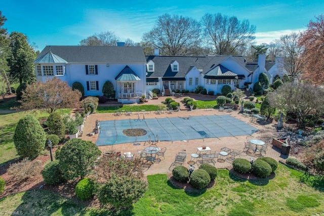 view of swimming pool with a patio and a lawn