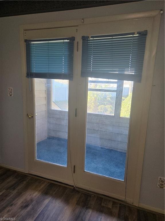 entryway with baseboards and dark wood finished floors