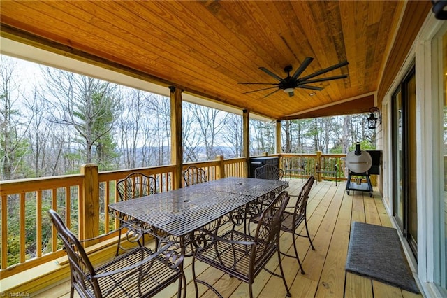 sunroom featuring a ceiling fan and wooden ceiling