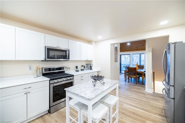 kitchen with stainless steel appliances, light wood-type flooring, and light countertops