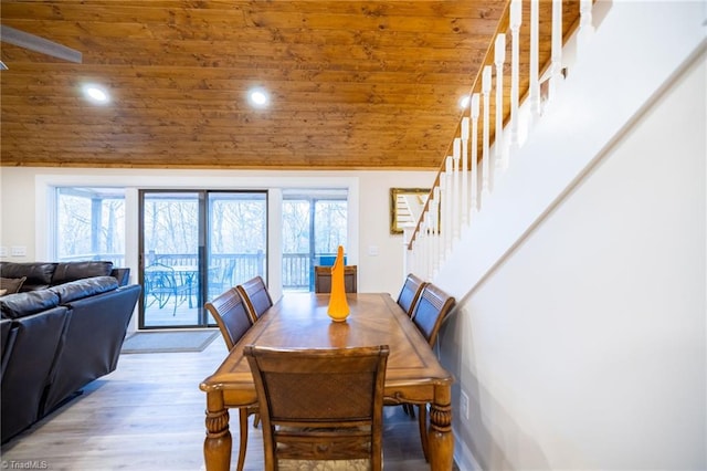 dining area with stairway, wooden ceiling, wood finished floors, and a healthy amount of sunlight