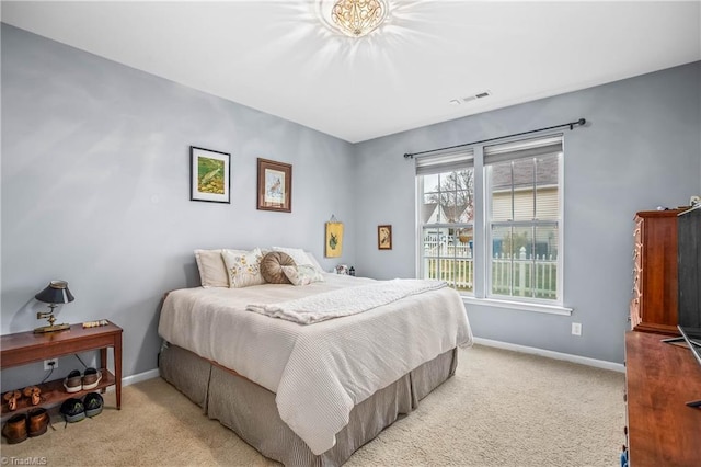 bedroom featuring light carpet