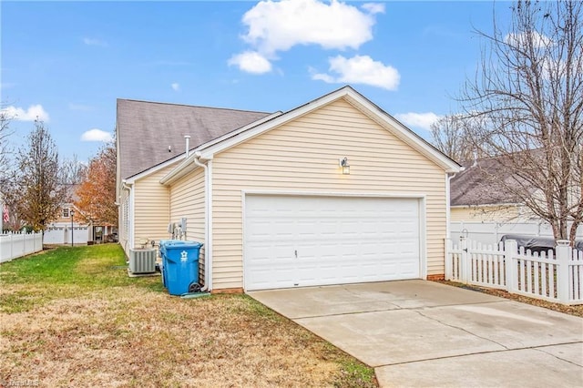 garage with a yard and central AC