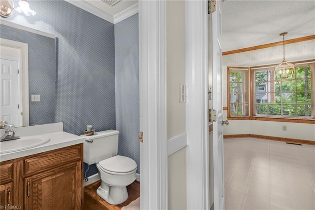 1113 Smokewood Dr, Apex, NC 27502 - bathroom with wallpapered walls, a chandelier, baseboards, vanity, and ornamental molding