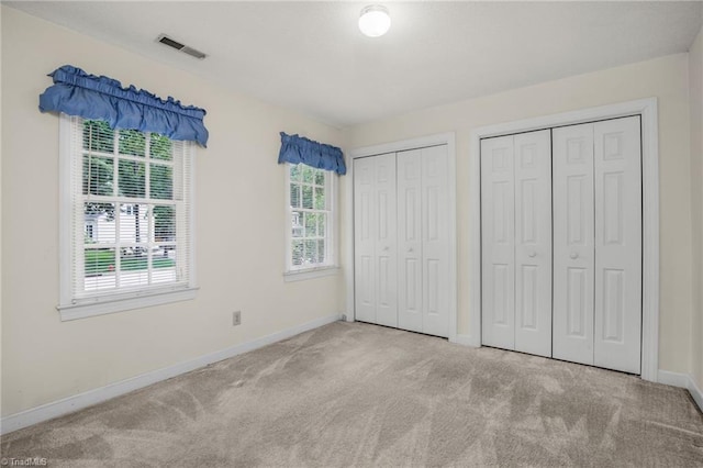 1113 Smokewood Dr, Apex, NC 27502 - unfurnished bedroom featuring carpet flooring, multiple closets, and baseboards