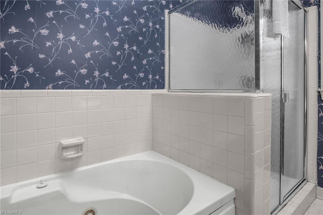 1113 Smokewood Dr, Apex, NC 27502 - full bathroom featuring wallpapered walls, a garden tub, a stall shower, and wainscoting