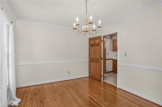 1113 Smokewood Dr, Apex, NC 27502 - spare room with a chandelier, ornamental molding, wood finished floors, and baseboards