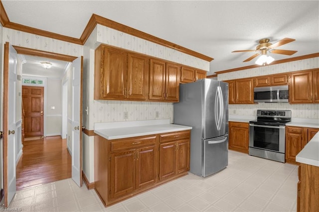 1113 Smokewood Dr, Apex, NC 27502 - kitchen with appliances with stainless steel finishes, light floors, crown molding, a ceiling fan, and brown cabinets