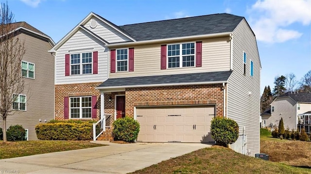 view of front of property featuring a garage, brick siding, driveway, and a front lawn