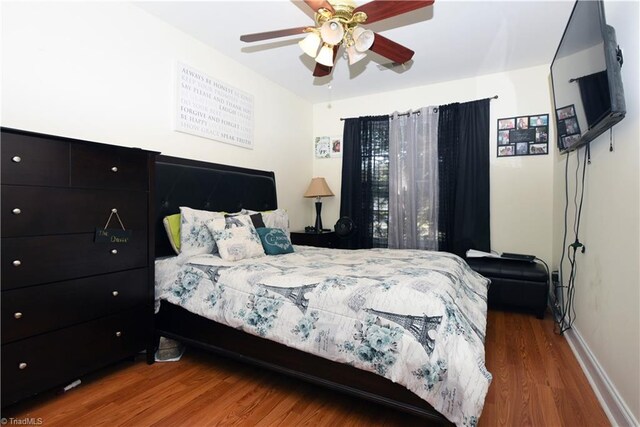 bedroom with hardwood / wood-style flooring and ceiling fan