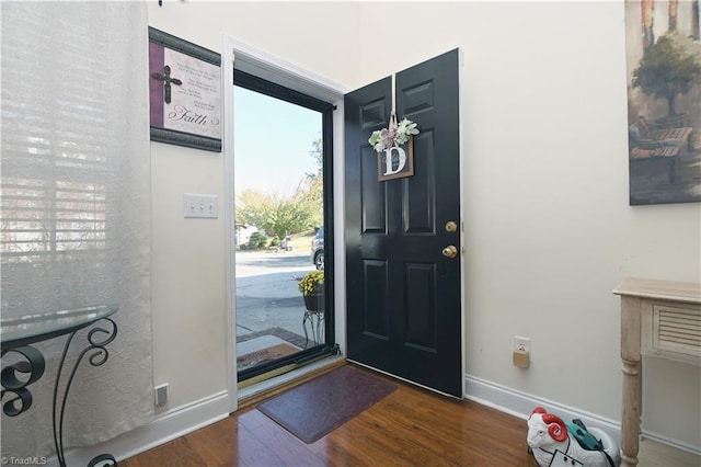 foyer featuring dark wood-type flooring and a healthy amount of sunlight